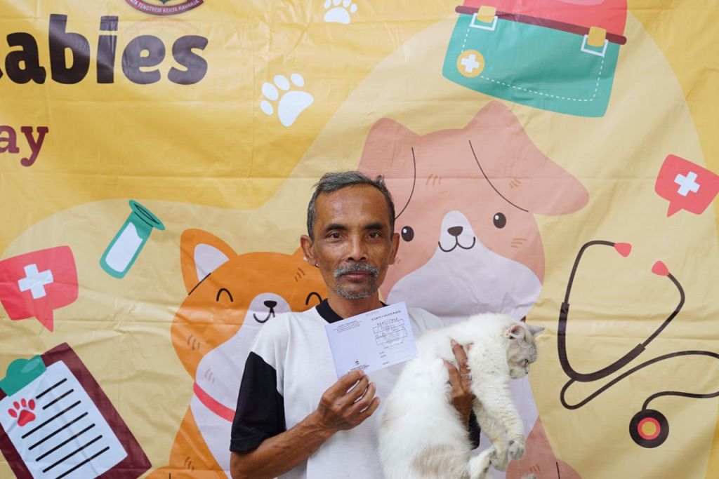 Seorang pecinta hewan di Garut membawa kucingnya untuk disuntuk vaksin anti-rabies.jpg
